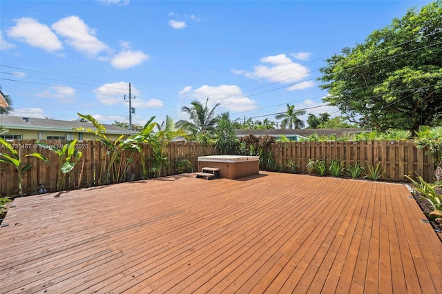 wooden deck with a hot tub