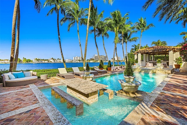 view of pool with a water view, a patio area, and a gazebo