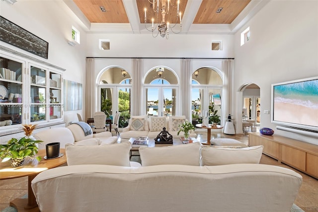 interior space with beam ceiling, wooden ceiling, french doors, and a chandelier