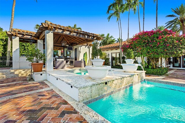 view of swimming pool with an in ground hot tub and a patio area