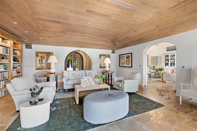 living room with a tray ceiling, vaulted ceiling, and wooden ceiling