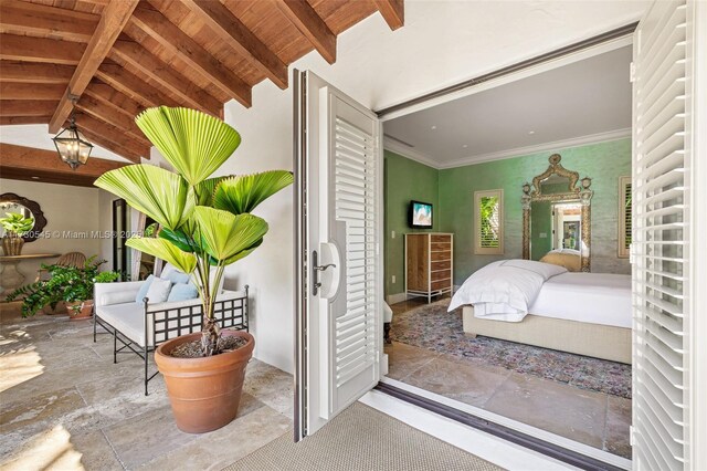 bedroom with ornamental molding, vaulted ceiling with beams, and wooden ceiling