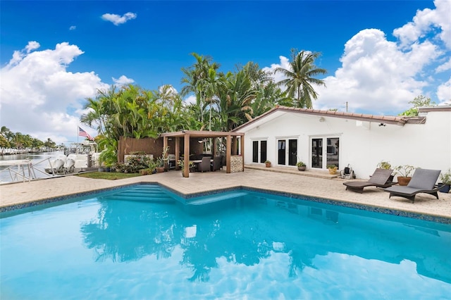 view of pool featuring a patio and french doors