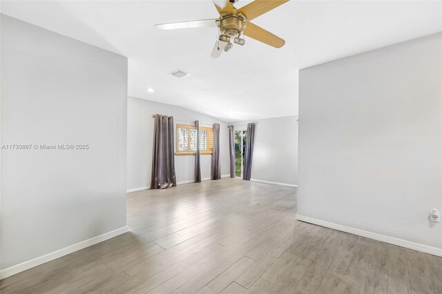 spare room with hardwood / wood-style flooring, plenty of natural light, and ceiling fan