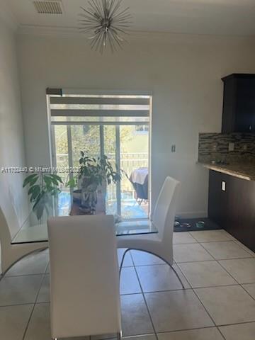 tiled dining space with ornamental molding