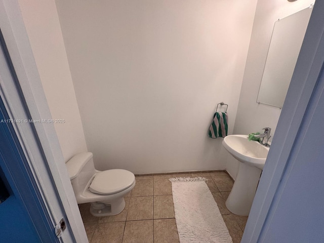 bathroom with sink, tile patterned floors, and toilet