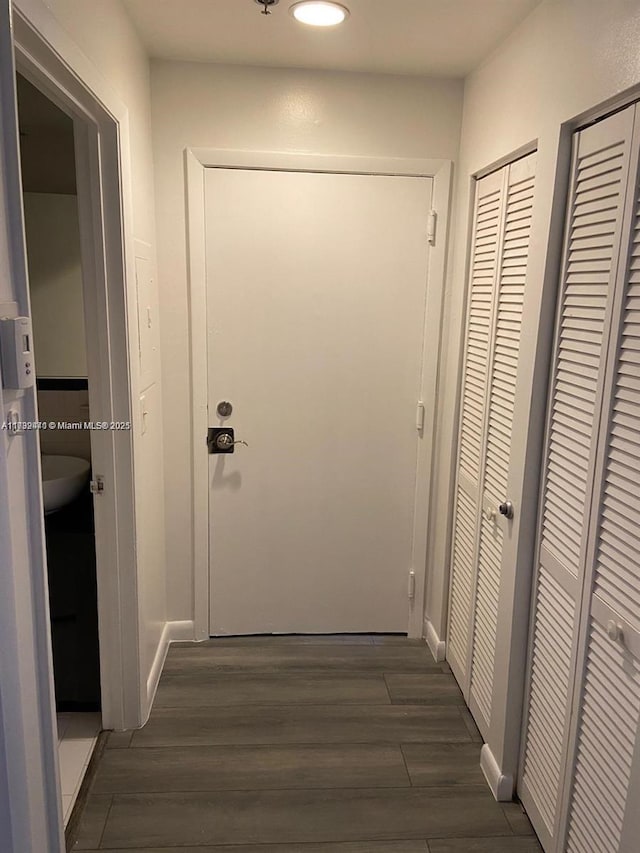 hallway with dark hardwood / wood-style flooring