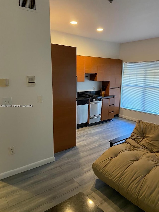 kitchen with stainless steel appliances and light hardwood / wood-style flooring