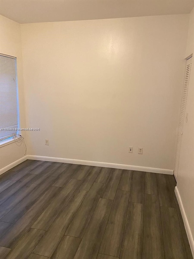 empty room featuring dark wood-type flooring