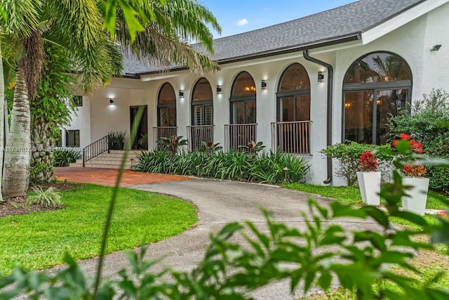 rear view of property featuring a yard