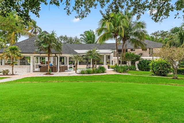 back of house featuring a yard, outdoor lounge area, and a patio area