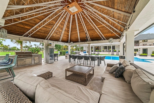 view of patio featuring a grill, a gazebo, an outdoor hangout area, and exterior kitchen