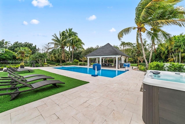 view of pool featuring a hot tub, a gazebo, and a patio