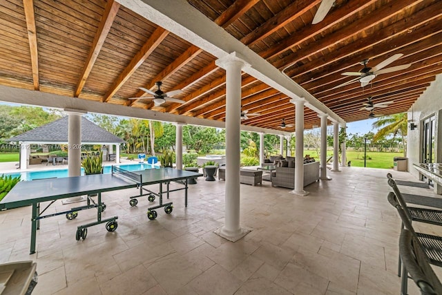 view of patio featuring a gazebo, ceiling fan, and an outdoor hangout area