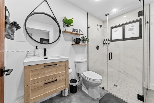 bathroom featuring vanity, a shower with shower door, and toilet