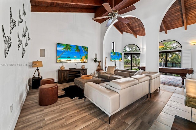 living room featuring wood ceiling, ceiling fan, high vaulted ceiling, and beamed ceiling