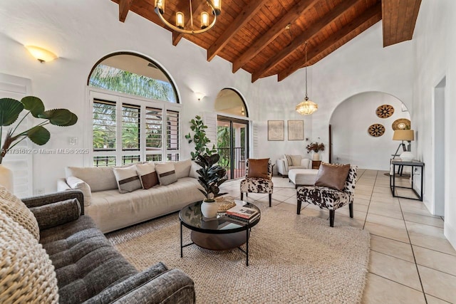 tiled living room with wood ceiling, a notable chandelier, beam ceiling, and high vaulted ceiling