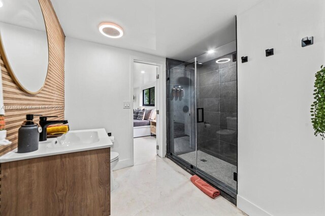 bathroom with concrete flooring, vanity, a shower with door, and toilet