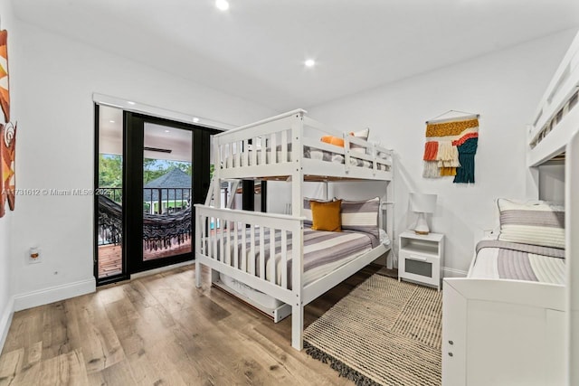 bedroom featuring access to exterior and hardwood / wood-style floors