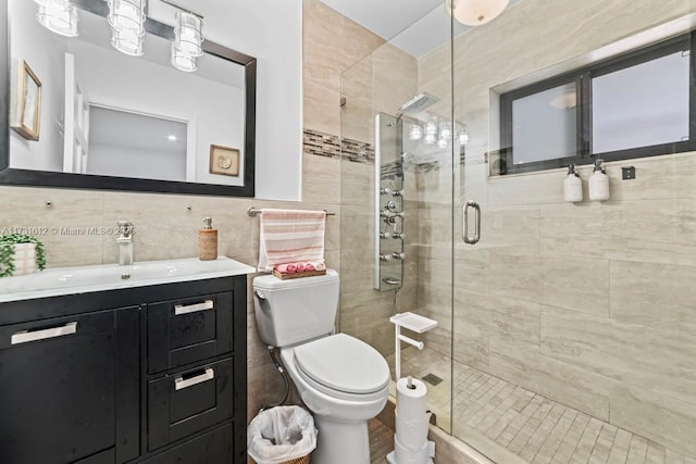 bathroom featuring vanity, an enclosed shower, tile walls, and backsplash