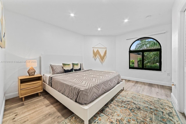 bedroom with hardwood / wood-style floors