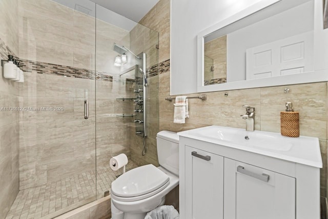 bathroom featuring tasteful backsplash, vanity, an enclosed shower, and toilet