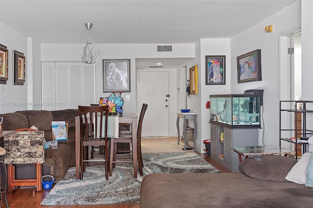 dining area featuring hardwood / wood-style floors and an inviting chandelier