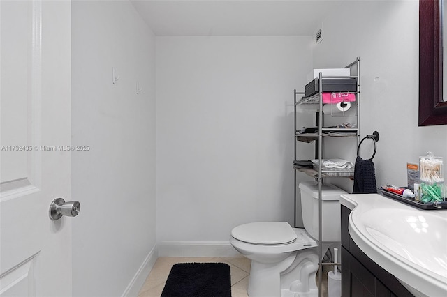 bathroom featuring tile patterned flooring, vanity, and toilet