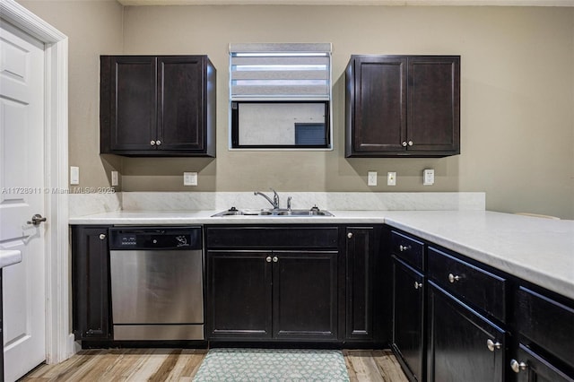 kitchen featuring dishwasher, sink, dark brown cabinets, and light wood-type flooring