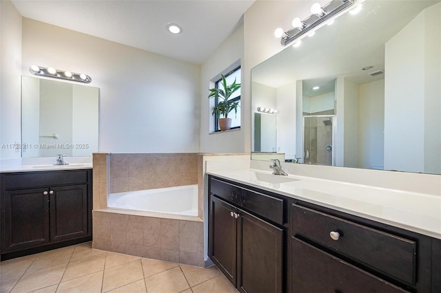 bathroom featuring vanity, tile patterned floors, and shower with separate bathtub