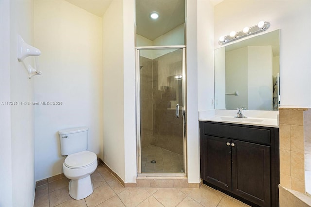 bathroom featuring vanity, a shower with shower door, tile patterned floors, and toilet