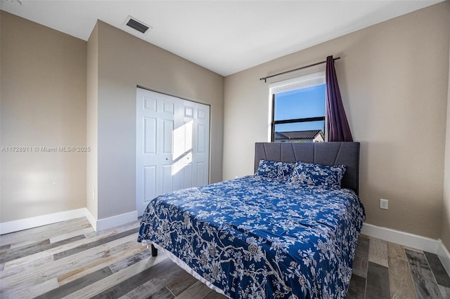 bedroom featuring hardwood / wood-style floors and a closet