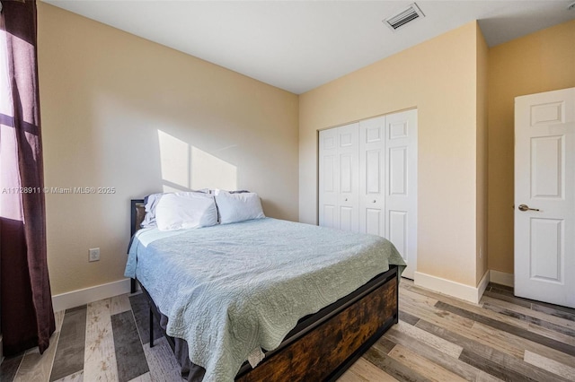 bedroom featuring a closet and light wood-type flooring