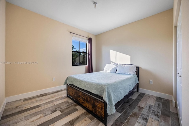 bedroom with hardwood / wood-style floors and a closet