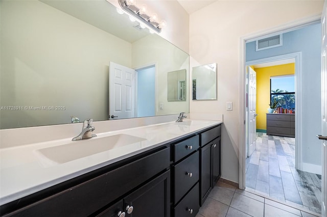 bathroom with tile patterned flooring and vanity