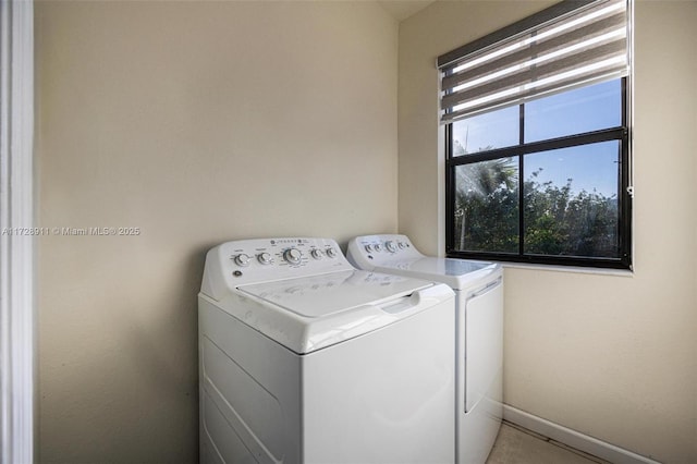 clothes washing area with washing machine and dryer