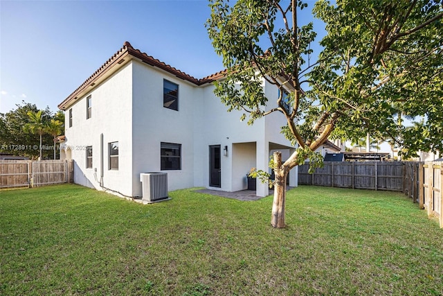 back of property with a yard and cooling unit