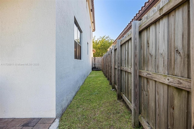 view of side of property with a yard