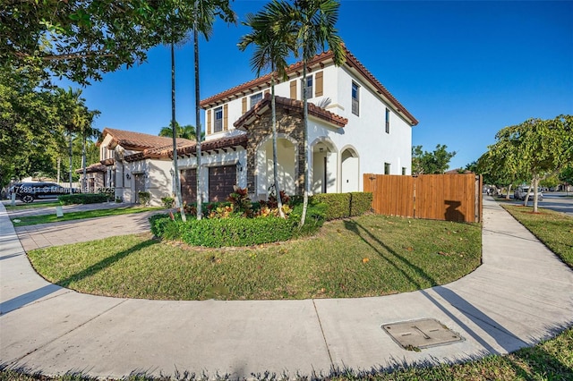 mediterranean / spanish house with a front yard