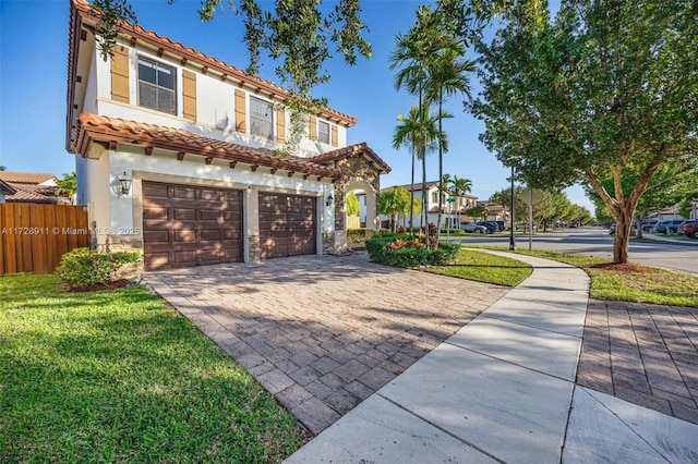 view of front of house with a garage and a front lawn