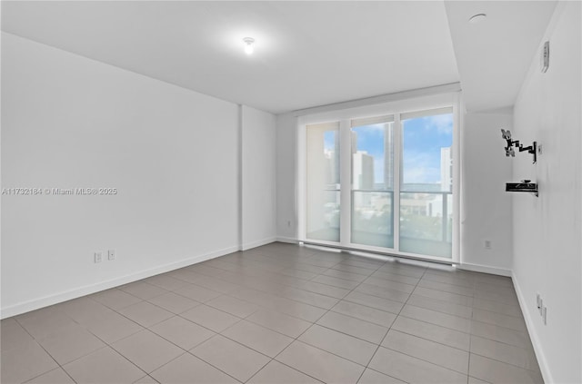 empty room with a wealth of natural light and light tile patterned floors