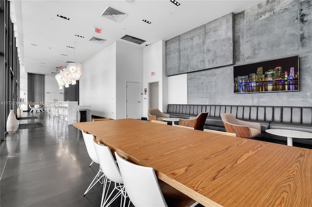 dining room featuring a towering ceiling