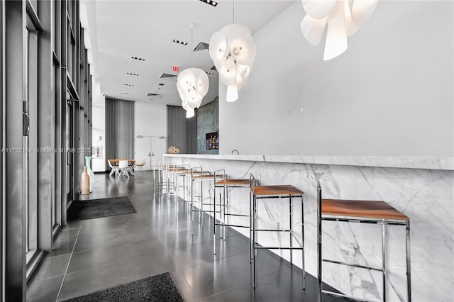 interior space featuring pendant lighting, a kitchen breakfast bar, and kitchen peninsula