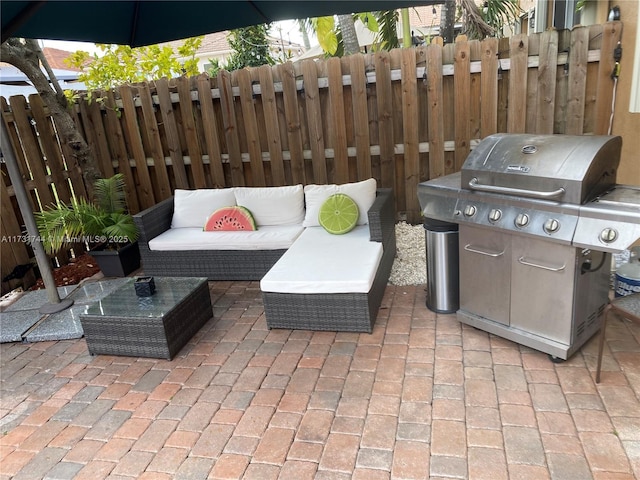 view of patio with outdoor lounge area and a grill