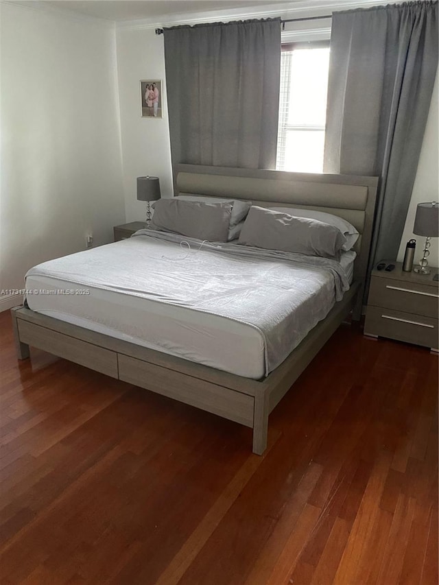 bedroom featuring dark wood-type flooring