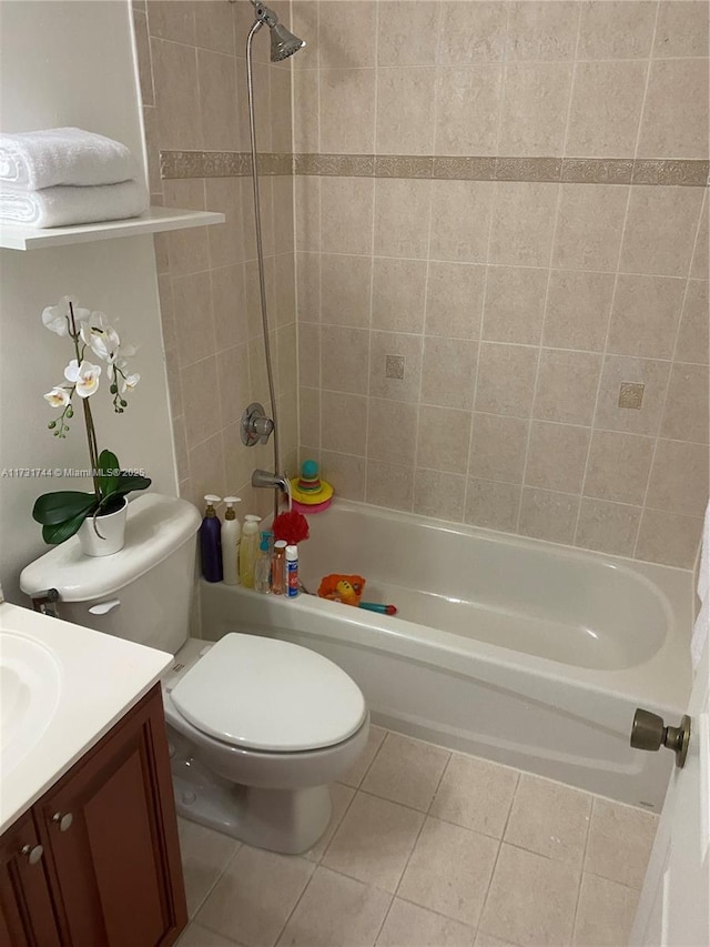 full bathroom featuring tile patterned floors, toilet, vanity, and tiled shower / bath