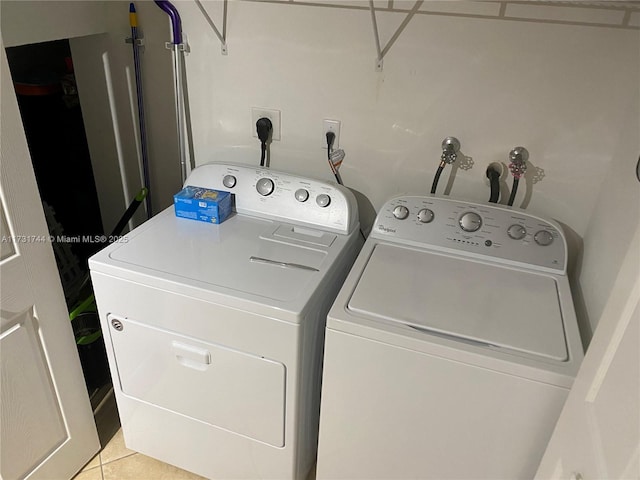 laundry area with light tile patterned floors and separate washer and dryer