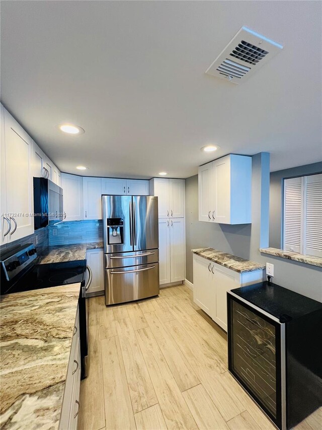 2301 S Ocean Dr Unit 2408, Hollywood, FL 33019 - kitchen with light stone counters, light wood-style flooring, stainless steel appliances, recessed lighting, and visible vents
