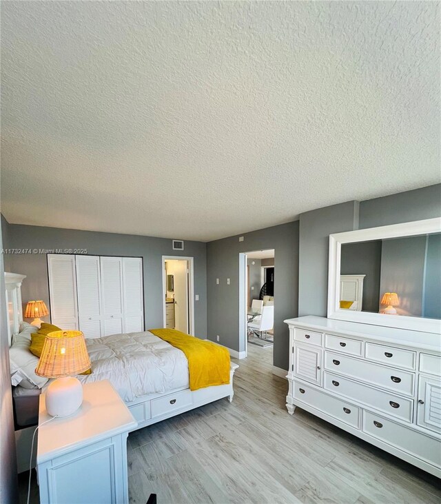 2301 S Ocean Dr Unit 2408, Hollywood, FL 33019 - bedroom with a textured ceiling, light wood finished floors, baseboards, and a closet
