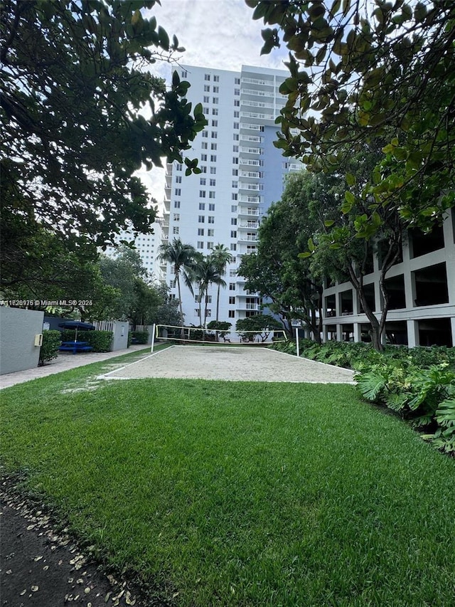 exterior space featuring a lawn and volleyball court